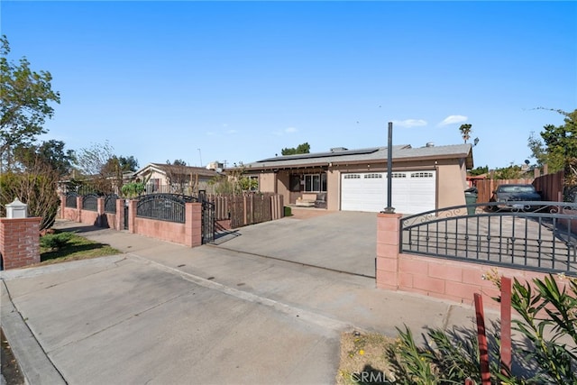 ranch-style house with a garage and solar panels