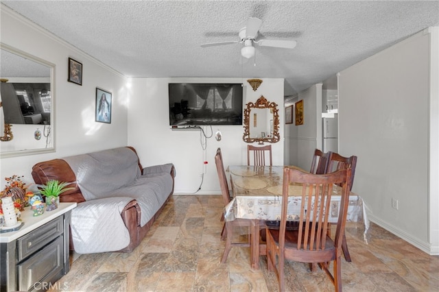 dining area featuring ceiling fan and a textured ceiling