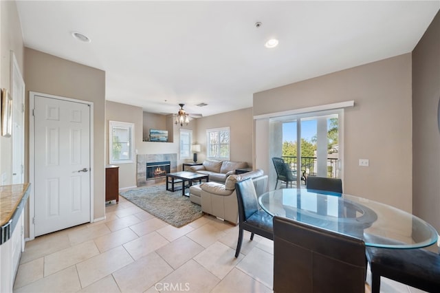 living room with a healthy amount of sunlight, light tile patterned floors, and ceiling fan