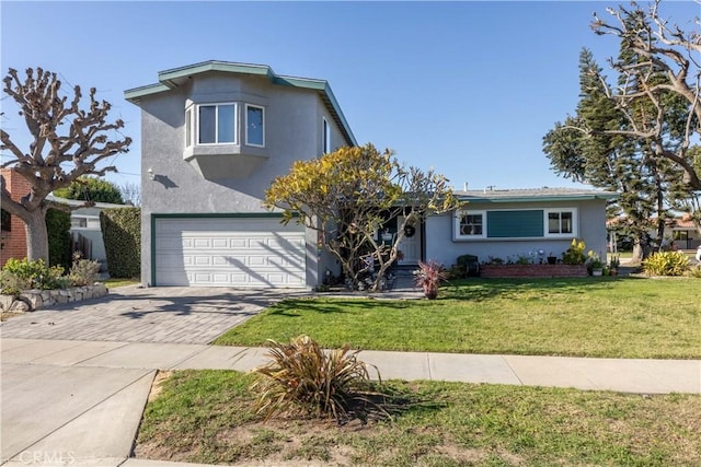 view of front property featuring a garage and a front lawn