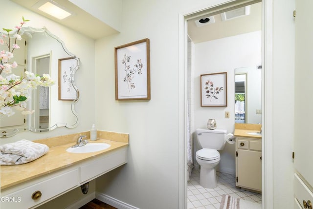 bathroom featuring vanity, tile patterned floors, and toilet