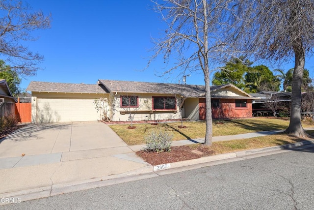 single story home featuring a garage and a front yard