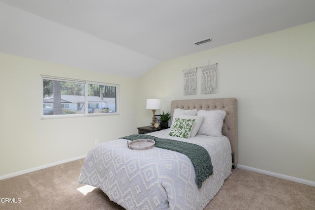 carpeted bedroom with lofted ceiling