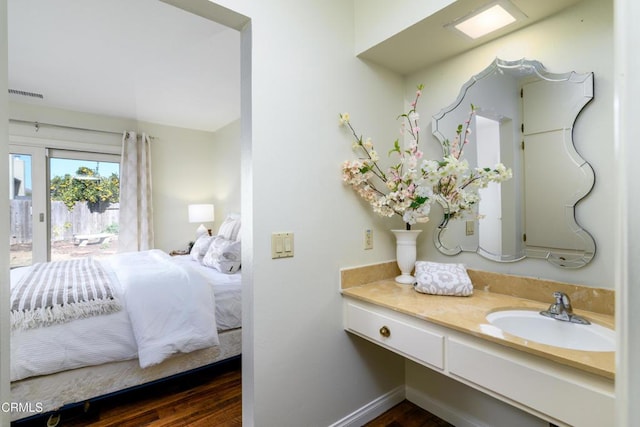 bedroom with sink and dark hardwood / wood-style floors