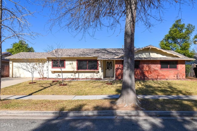 ranch-style house featuring a garage and a front yard