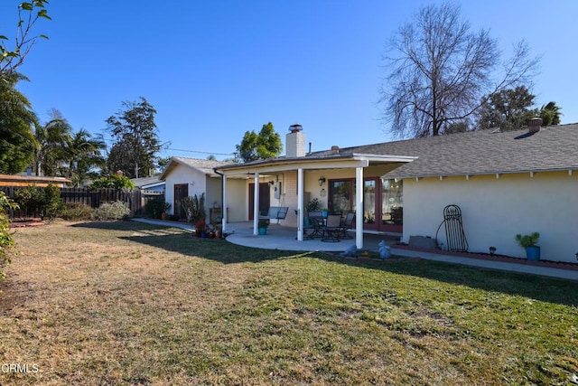 rear view of property with a patio and a yard