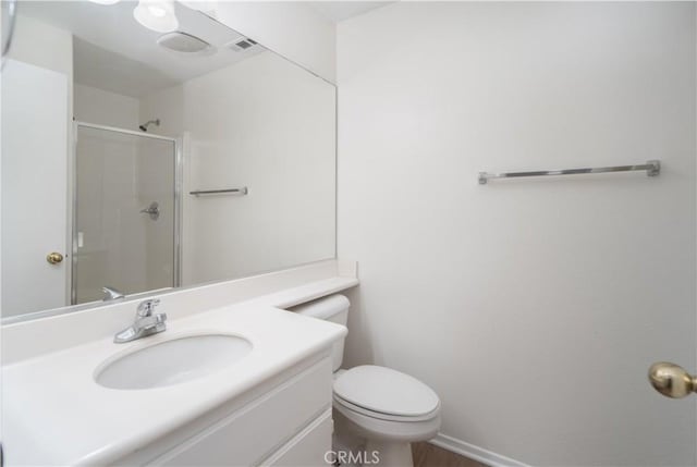 bathroom with vanity, an enclosed shower, and toilet