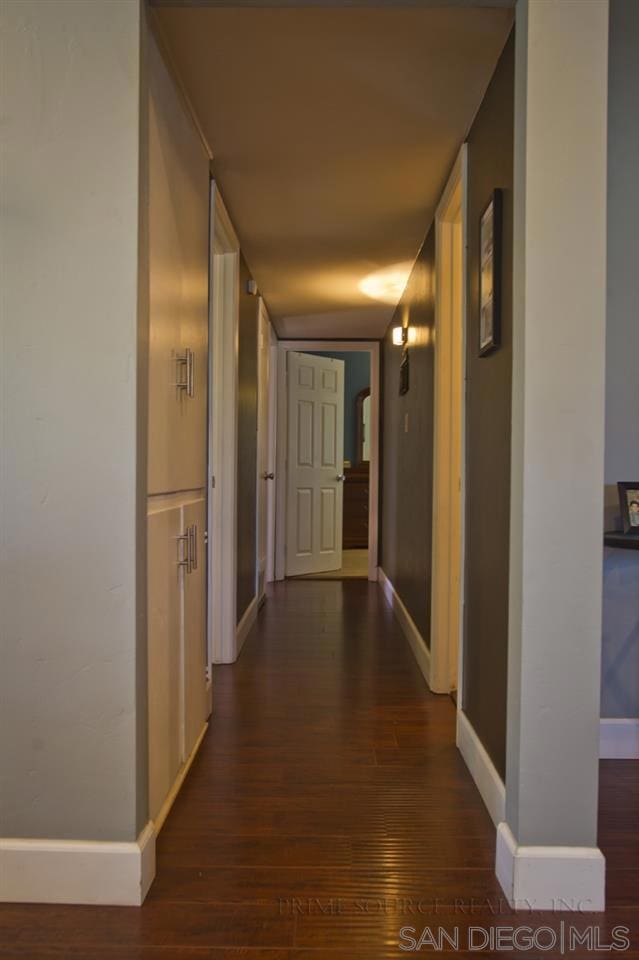 hallway with dark hardwood / wood-style floors