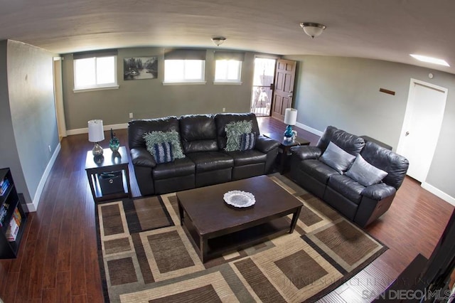 living room featuring dark hardwood / wood-style flooring and lofted ceiling