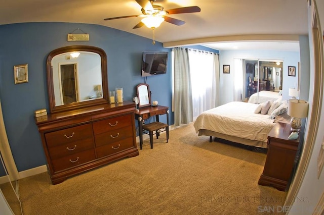 bedroom featuring light carpet, vaulted ceiling, and ceiling fan