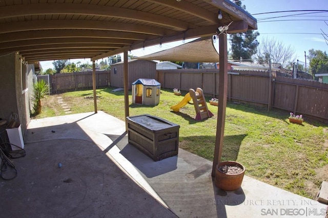 view of patio / terrace with a shed and a playground