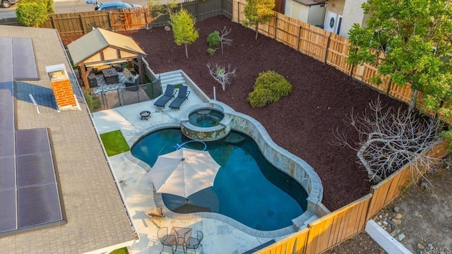 view of pool with an in ground hot tub, a fire pit, a patio area, and a gazebo