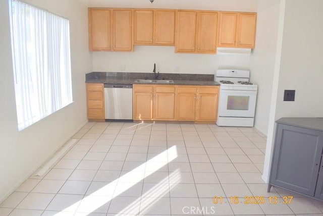 kitchen with sink, gas range gas stove, light tile patterned floors, dishwasher, and a healthy amount of sunlight