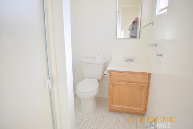 bathroom featuring vanity, tile patterned floors, and toilet