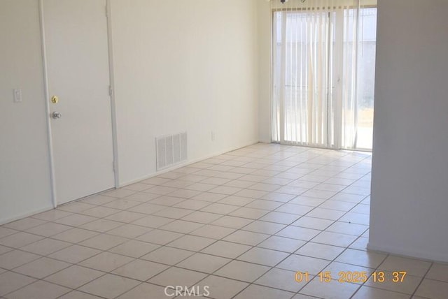 empty room with light tile patterned floors