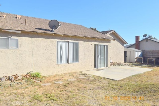 back of property featuring a yard and a patio