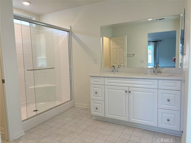 bathroom with a shower with door and vanity