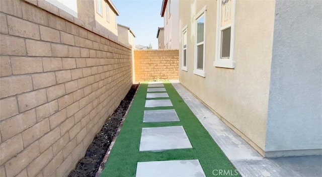 view of home's exterior featuring stucco siding and fence