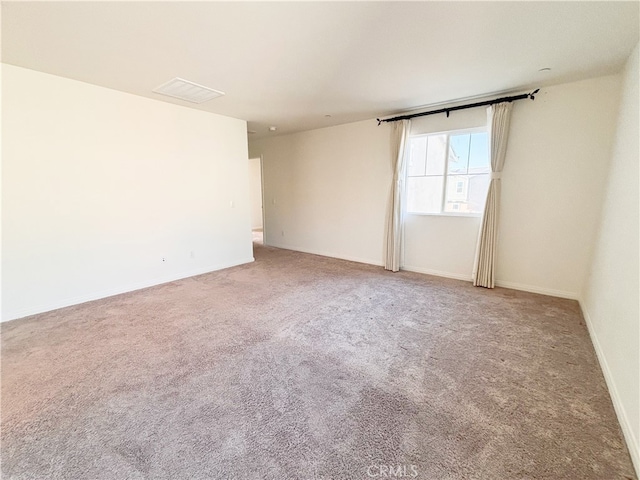 spare room featuring baseboards and carpet floors