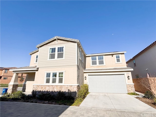 craftsman house featuring stucco siding, concrete driveway, a garage, stone siding, and board and batten siding