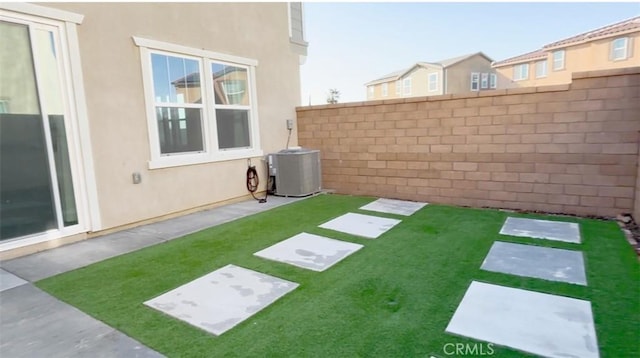 view of yard with cooling unit and fence