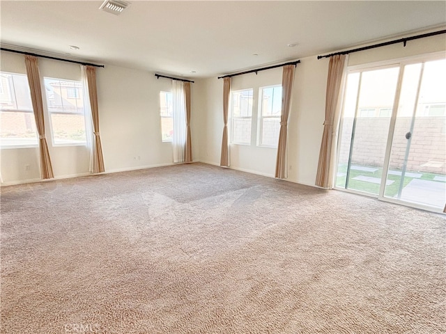 carpeted empty room featuring visible vents