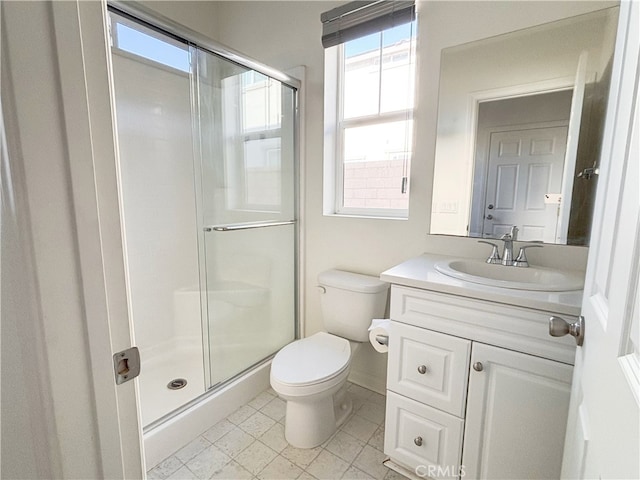 full bathroom featuring vanity, toilet, and a shower stall