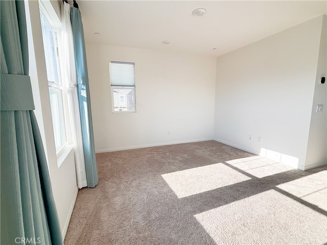 unfurnished room featuring baseboards and carpet floors