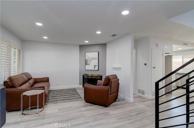 living room with light hardwood / wood-style flooring