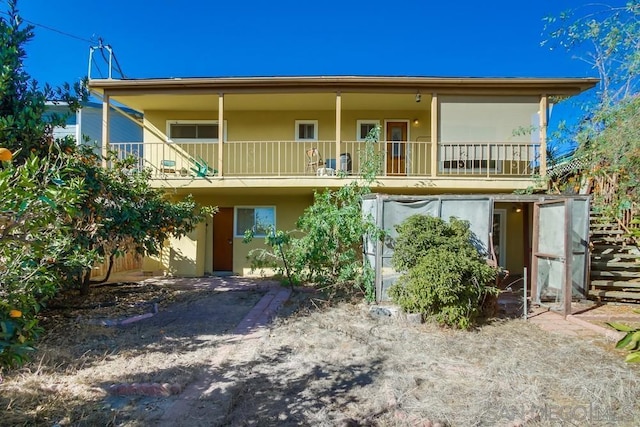 back of house with a balcony