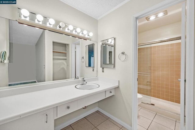 bathroom featuring sink, a shower with door, tile patterned floors, and a textured ceiling