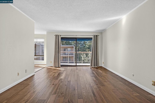 spare room with hardwood / wood-style floors and a textured ceiling