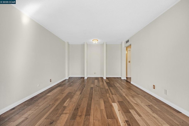 spare room featuring wood-type flooring