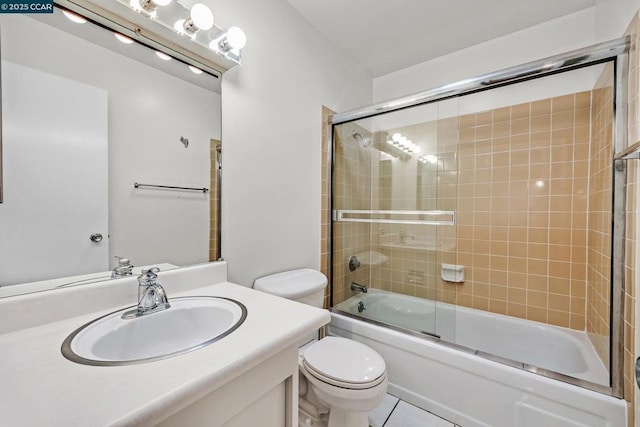 full bathroom featuring tile patterned flooring, enclosed tub / shower combo, vanity, and toilet