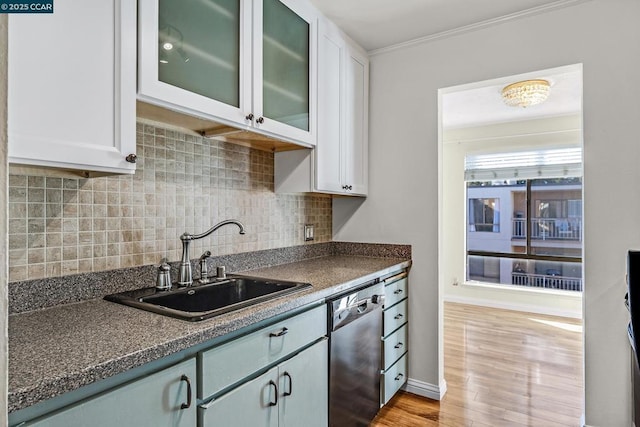 kitchen with sink, dishwasher, white cabinetry, tasteful backsplash, and light hardwood / wood-style floors