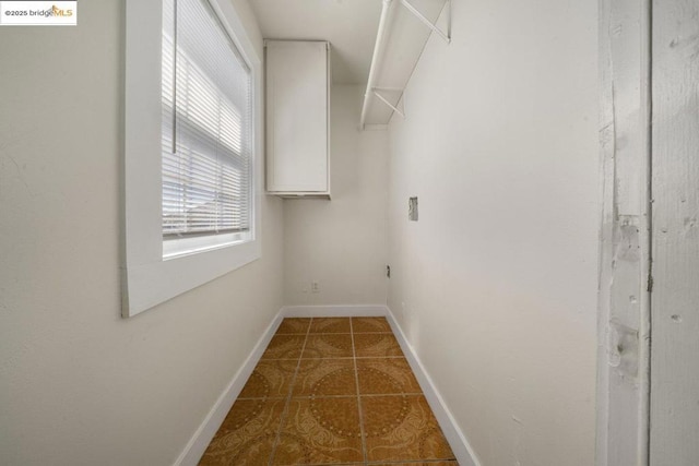 walk in closet featuring dark tile patterned floors