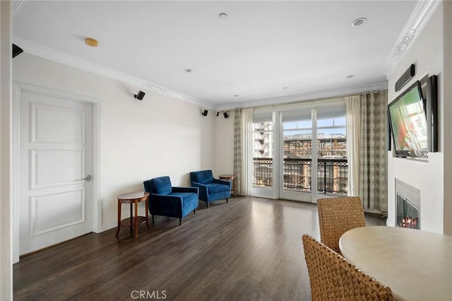 sitting room with ornamental molding and dark hardwood / wood-style flooring