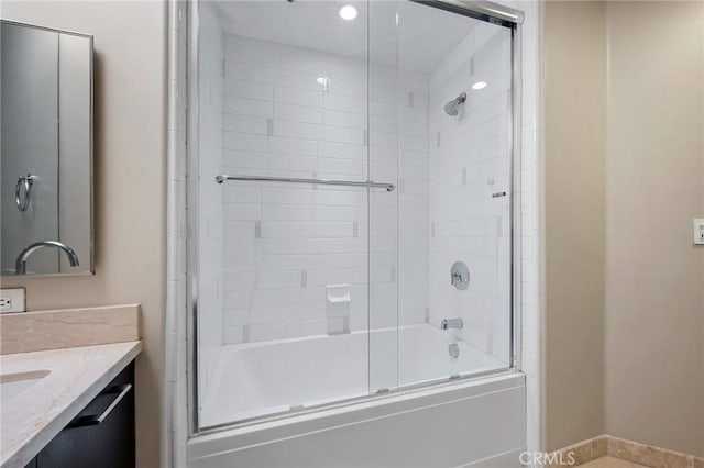 bathroom featuring vanity and combined bath / shower with glass door