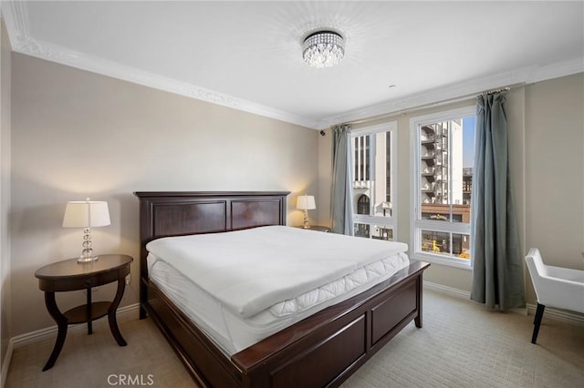 bedroom with light carpet and crown molding