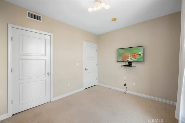 unfurnished bedroom with light colored carpet