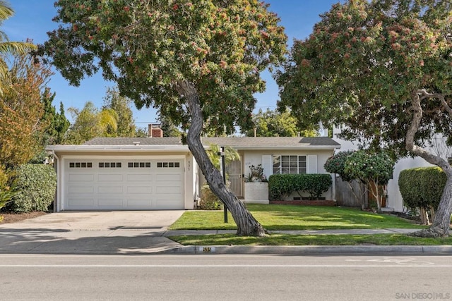 view of front facade with a garage and a front yard