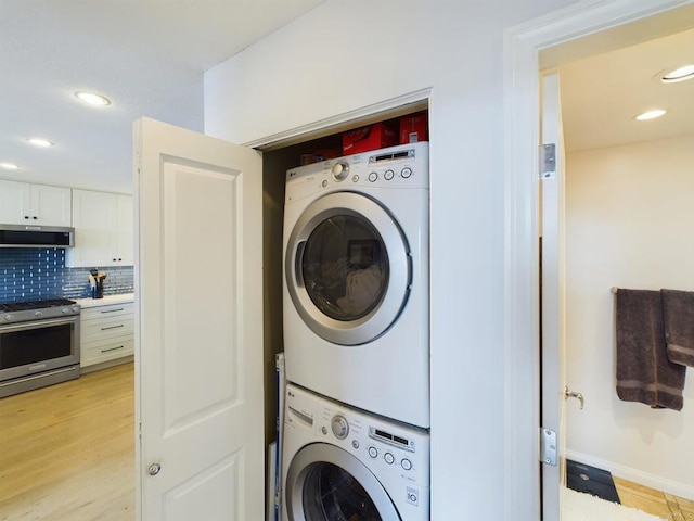 laundry area with stacked washing maching and dryer