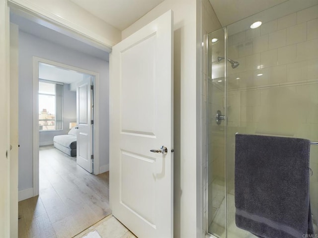 bathroom featuring an enclosed shower and hardwood / wood-style floors