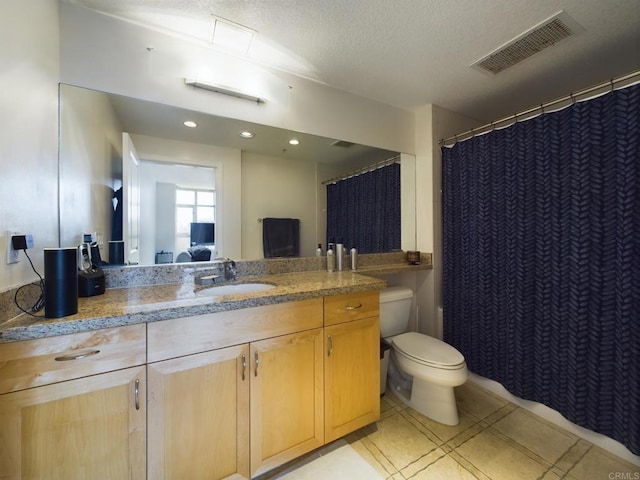 bathroom featuring vanity, toilet, and tile patterned flooring