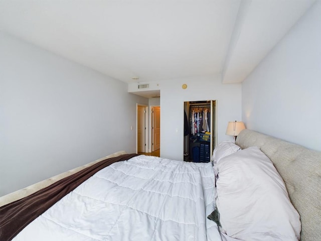 bedroom featuring a spacious closet and a closet