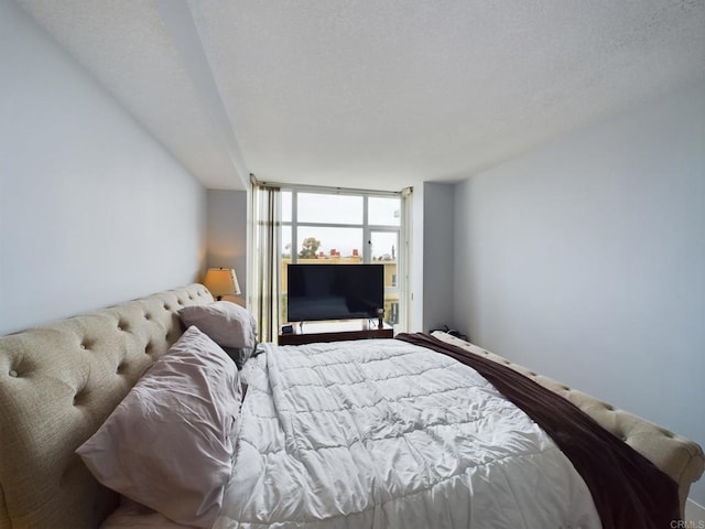 bedroom featuring a wall of windows