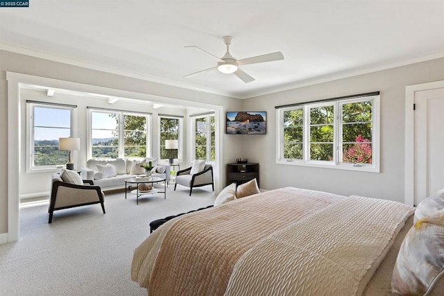 carpeted bedroom with ornamental molding and ceiling fan