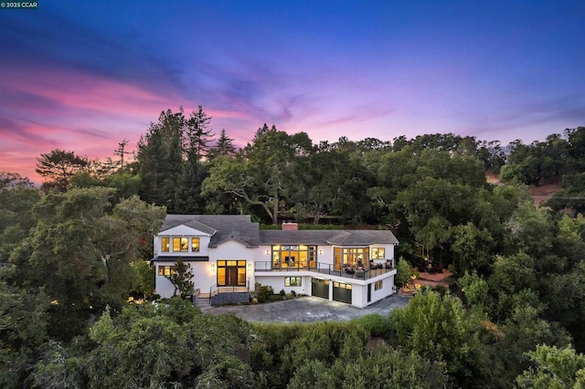 back house at dusk with a garage