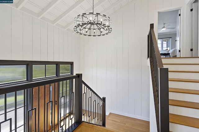 stairs with wood ceiling, hardwood / wood-style flooring, lofted ceiling with beams, and a chandelier