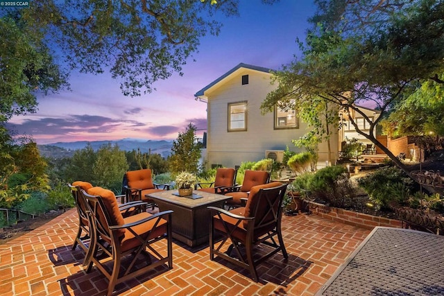 patio terrace at dusk featuring a fire pit